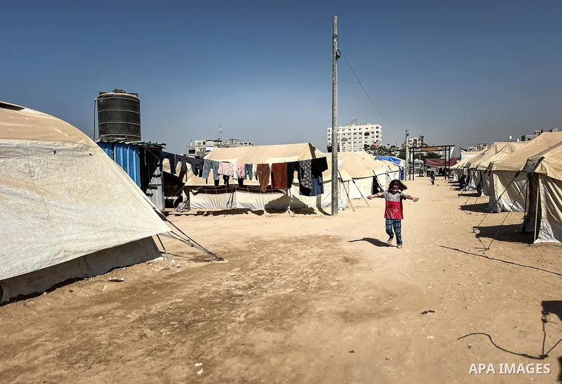 Displaced Palestinian families, including orphans, live in a temporary camp within Al-Bureij refugee camp in central Gaza, where worn-out tents have become their only shelter after losing their homes and loved ones durin...