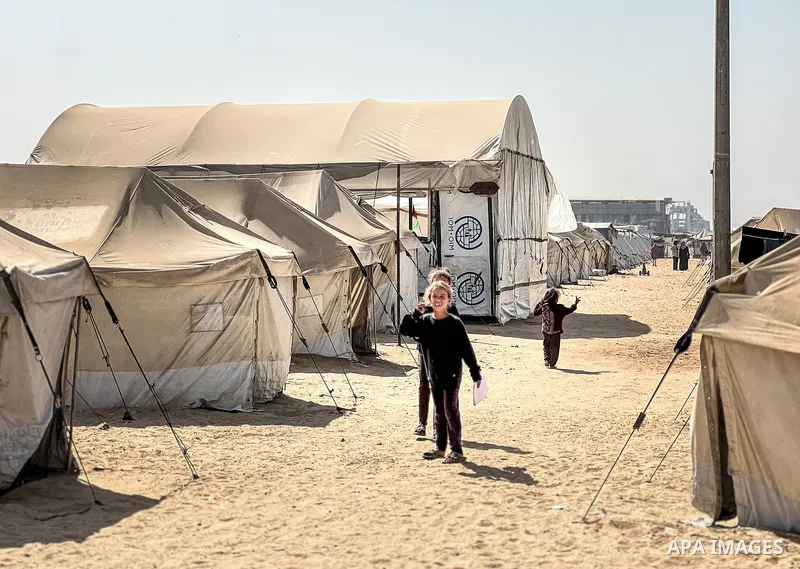 Displaced Palestinian families, including orphans, live in a temporary camp within Al-Bureij refugee camp in central Gaza, where worn-out tents have become their only shelter after losing their homes and loved ones durin...