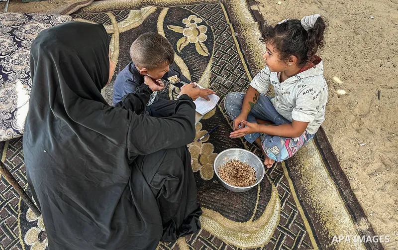 Displaced Palestinian families, including orphans, live in a temporary camp within Al-Bureij refugee camp in central Gaza, where worn-out tents have become their only shelter after losing their homes and loved ones durin...