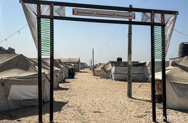 Displaced Palestinian families, including orphans, live in a temporary camp within Al-Bureij refugee camp in central Gaza, where worn-out tents have become their only shelter after losing their homes and loved ones durin...