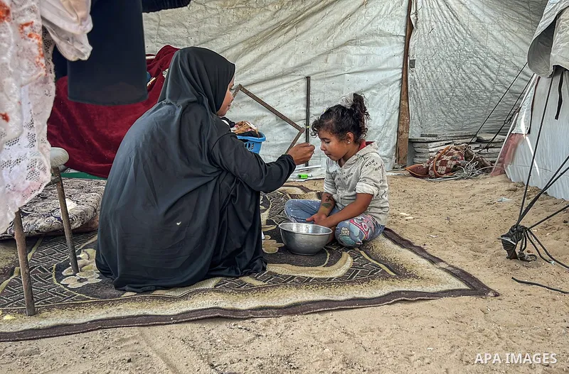 Displaced Palestinian families, including orphans, live in a temporary camp within Al-Bureij refugee camp in central Gaza, where worn-out tents have become their only shelter after losing their homes and loved ones durin...