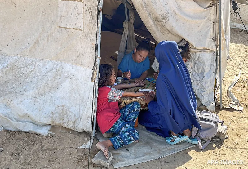 Displaced Palestinian families, including orphans, live in a temporary camp within Al-Bureij refugee camp in central Gaza, where worn-out tents have become their only shelter after losing their homes and loved ones durin...