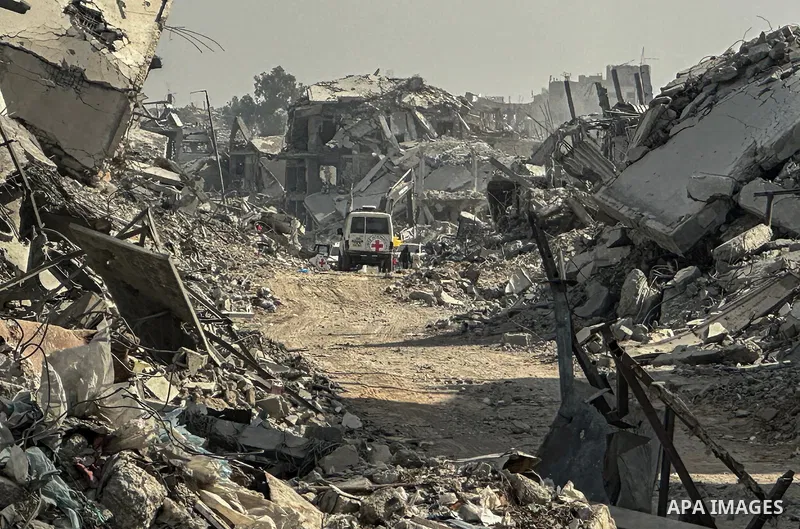 Machinery is working alongside a Red Cross vehicle in the area known as the "Yellow Line," to which Israeli forces withdrew under the ceasefire, where Hamas says it is continuing to search for the bodies of prisoners cap...