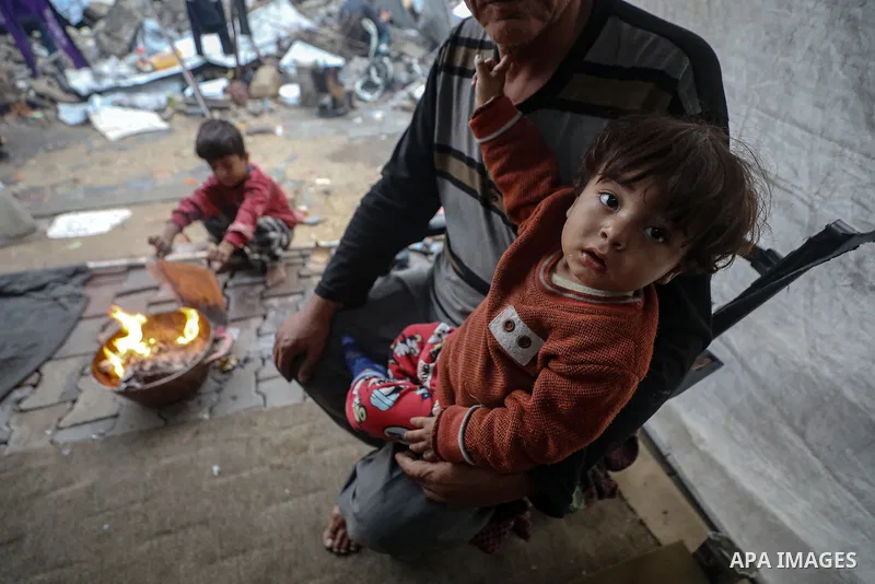 Elderly Palestinian couple Umm Mohammed and Abu Mohammed Al-Aliwa, from Gaza City’s Shujaiya neighborhood, care for 36 grandchildren after losing five of their sons during the war. The family lives in a tent under diffic...