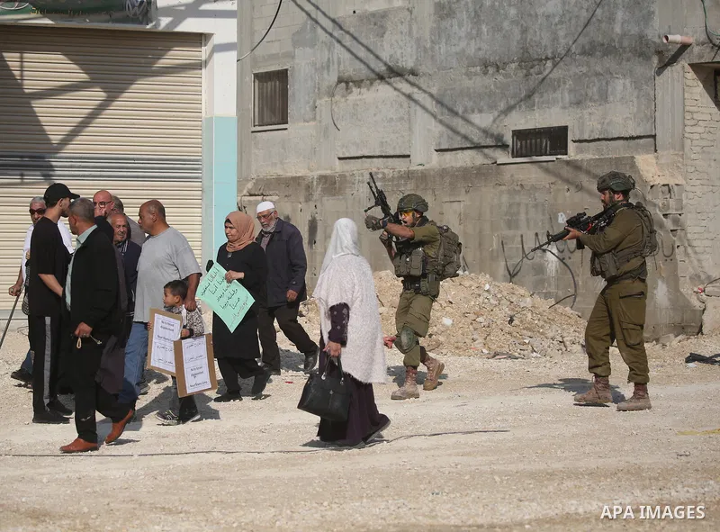 Displaced Palestinians stage a protest at the entrance to the Nur Shams refugee camp in the West Bank, calling for their right to return to their homes in Tulkarm. Israeli forces block the demonstration and detain severa...