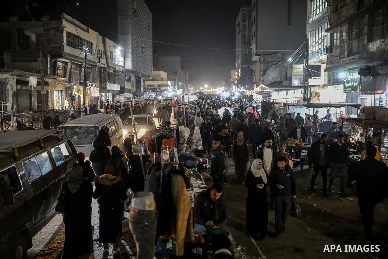 Palestinians walk through the Omar Mukhtar Market in the Rimal neighborhood of Gaza City on December 31, 2025, the final day of 2025, as the market, which has become a refuge for residents following Israeli destruction,...