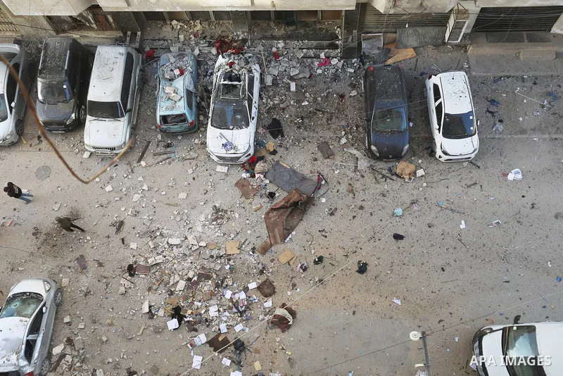 Palestinians walk past an apartment building damaged by an Israeli military strike that killed several people in Gaza City, Saturday, Jan. 31, 2026. Photo by Omar Ashtawy\ apaimages