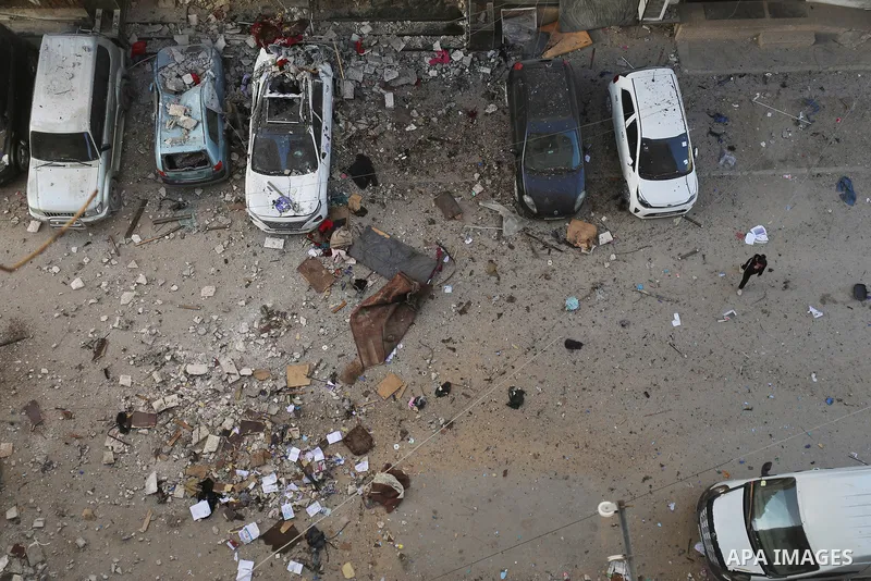 Palestinians walk past an apartment building damaged by an Israeli military strike that killed several people in Gaza City, Saturday, Jan. 31, 2026. Photo by Omar Ashtawy\ apaimages