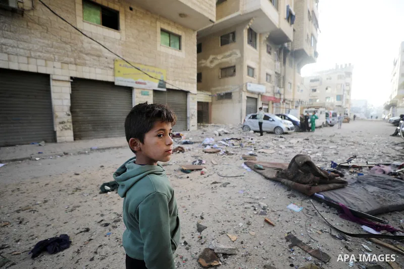 Palestinians walk past an apartment building damaged by an Israeli military strike that killed several people in Gaza City, Saturday, Jan. 31, 2026. Photo by Omar Ashtawy\ apaimages