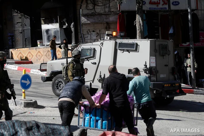 Israeli forces carry out a raid on the city of Hebron, the West Bank on January 31, 2026. During the raid, Israeli military bulldozers placed concrete blocks on many streets across the city, restricting the movement of P...