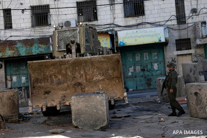Israeli forces carry out a raid on the city of Hebron, the West Bank on January 31, 2026. During the raid, Israeli military bulldozers placed concrete blocks on many streets across the city, restricting the movement of P...