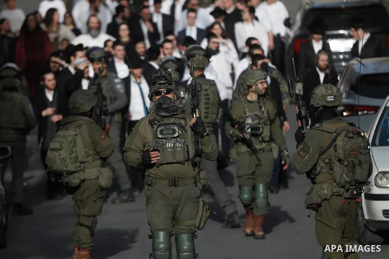 Israeli settlers, under the protection of Israeli forces, raid the Old City of Hebron in the southern West Bank on January 31, 2026. During the raid, Israeli soldiers were seen taking security measures in the area. Photo...