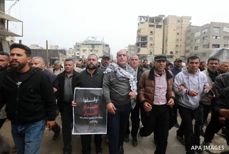 Palestinian demonstrators march through the Gaza City on April 1, 2026, during a protest against the Israeli parliament's approval of a new death penalty bill for Palestinians convicted of deadly attacks. The bill would...