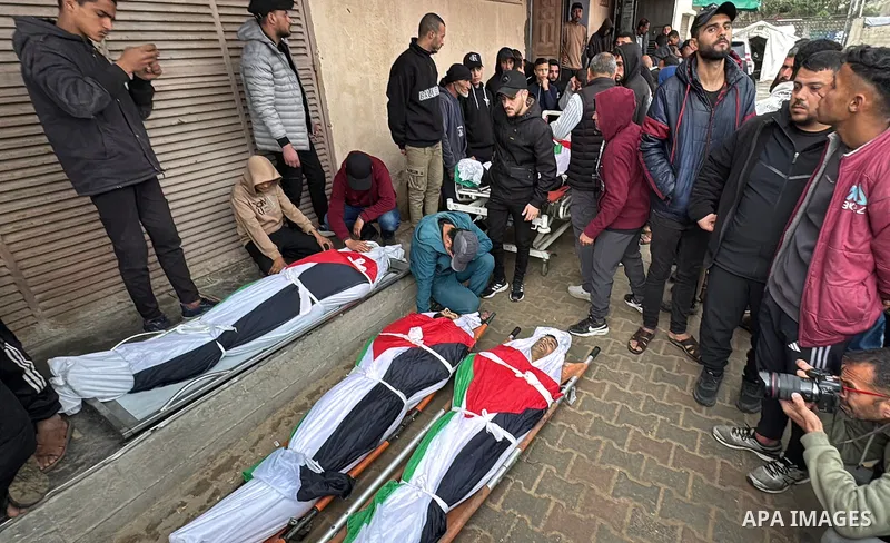 Relatives take a last look at the bodies of Palestinians killed during an Israeli airstrike east of the Al-Maghazi refugee camp, inside the Al-Aqsa Martyrs Hospital in Deir al-Balah in the central Gaza Strip on April 7,...