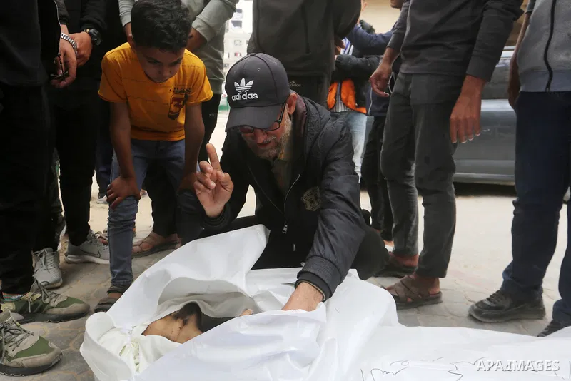 Palestinians mourn over the bodies of civilians killed in an Israeli strike in the northern Gaza Strip, during a funeral at Al-Shifa Hospital in Gaza City, on April 26, 2026. Photo by Belal Osama \ apaimages