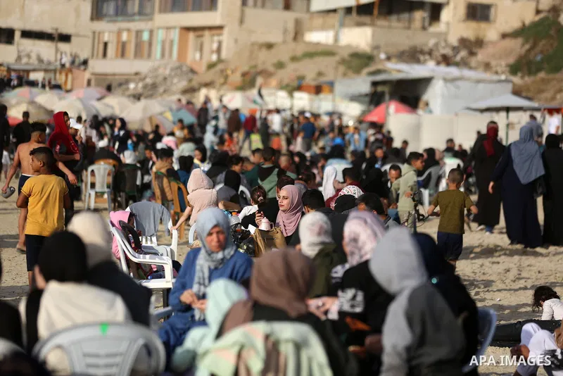 Displaced Palestinians spend time on the beach west of Gaza City on May 8, 2026, seeking relief from difficult living conditions. The coastline has become a refuge for thousands of displaced families living in tents afte...