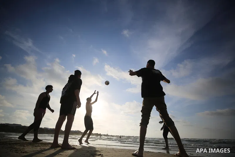 Displaced Palestinians spend time on the beach west of Gaza City on May 8, 2026, seeking relief from difficult living conditions. The coastline has become a refuge for thousands of displaced families living in tents afte...