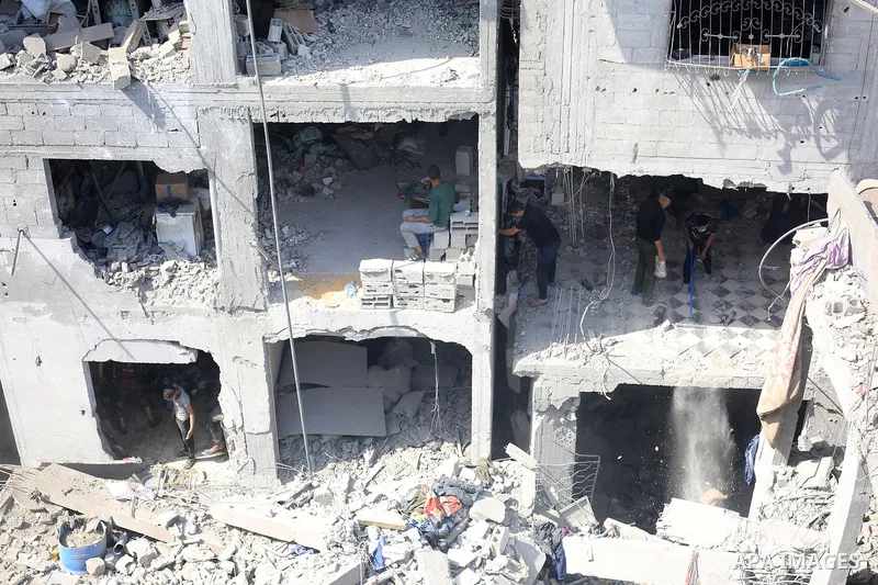 Palestinians inspect damaged buildings following an Israeli airstrike on Al-Shati Camp in western Gaza City, Gaza Strip, on May 09, 2026. Palestinian families returned to the site of the blast to search through the rubbl...