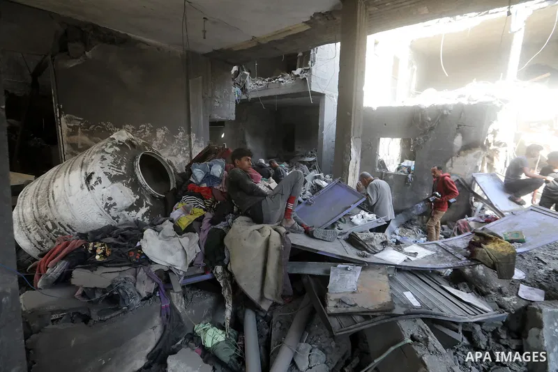 Palestinians inspect damaged buildings following an Israeli airstrike on Al-Shati Camp in western Gaza City, Gaza Strip, on May 09, 2026. Palestinian families returned to the site of the blast to search through the rubbl...