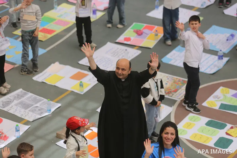 Palestinian Muslim and Christian children take part in a reading exhibition inside the Holy Family Catholic Church in the al-Zeitoun neighborhood of Gaza City on May 11, 2026, following months of education and psychologi...