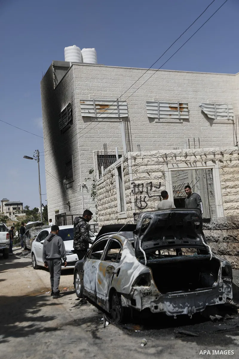 Palestinians inspect damage to their vehicles and property after they were set on fire by Israeli settlers overnight in the town of Halhul, north of Hebron in the occupied West Bank, on May 20, 2026. Local residents said...