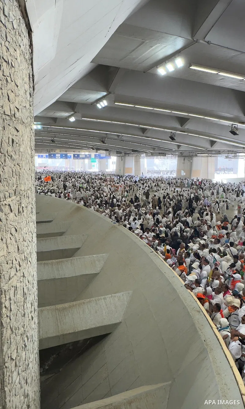 Muslim pilgrims walk on the first day of the symbolic stoning ritual during the annual Hajj pilgrimage in Mina, Saudi Arabia, on May 27, 2026. The ritual, known as the stoning of the devil, is one of the main rites of Ha...