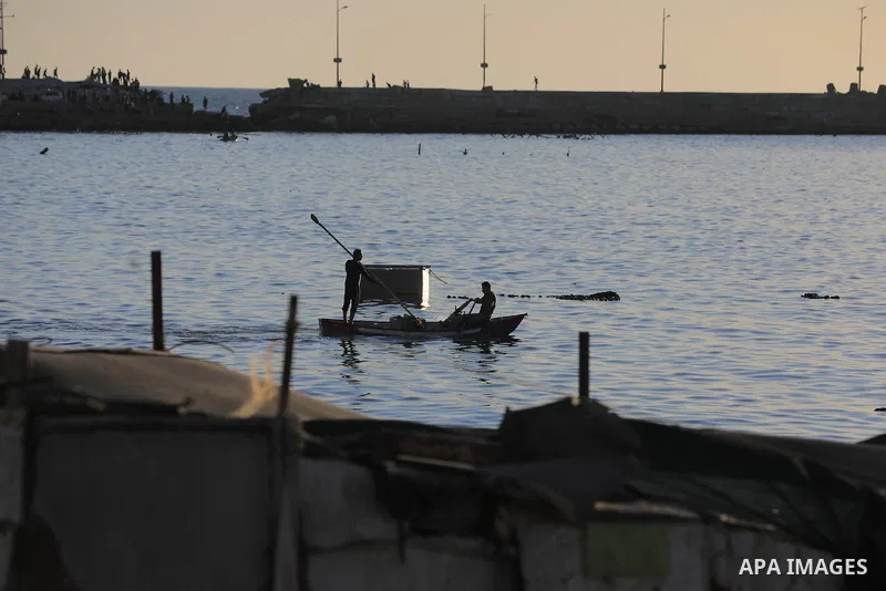 Palestinians gather along the beach at the Gaza City on June 5, 2026, during hot weather conditions. Despite a truce technically in effect since October 2025, daily violence has continued across the Gaza Strip, more than...