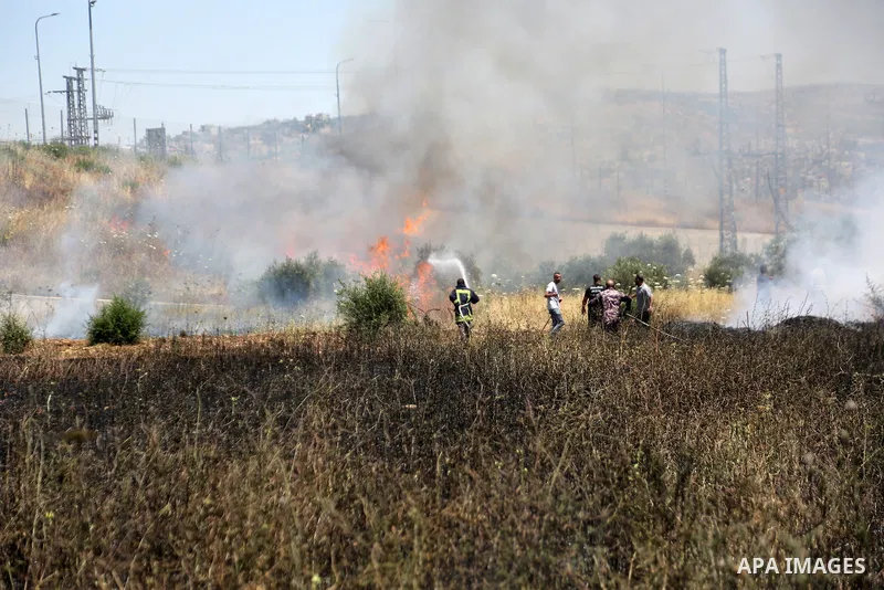 Firefighters and Palestinians work to extinguish fires in agricultural fields near the town of Huwara, south of the West Bank city of Nablus, on June 6, 2026. Local residents reported that settlers stole 32 sheep belongi...