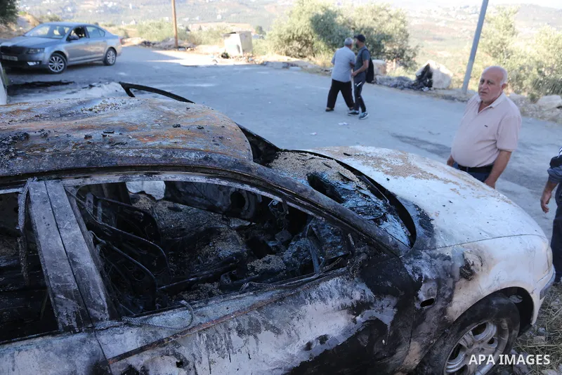 Palestinians inspect a burned house and vehicle following an attack by Israeli settlers on Palestinian homes, vehicles and property in the village of Beit Ammar, north of Nablus in the occupied West Bank, on June 9, 2026...