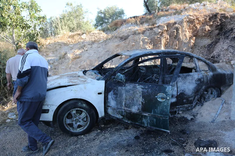 Palestinians inspect a burned house and vehicle following an attack by Israeli settlers on Palestinian homes, vehicles and property in the village of Beit Ammar, north of Nablus in the occupied West Bank, on June 9, 2026...