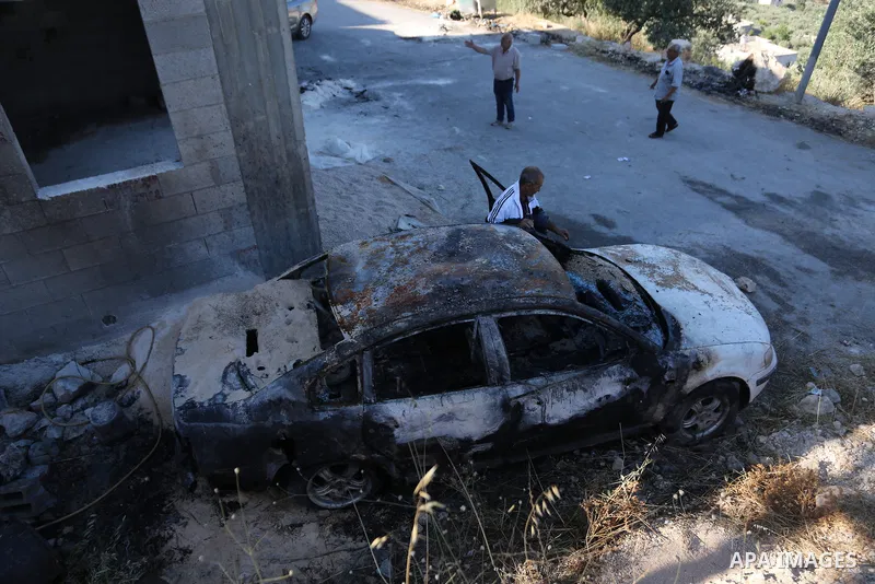 Palestinians inspect a burned house and vehicle following an attack by Israeli settlers on Palestinian homes, vehicles and property in the village of Beit Ammar, north of Nablus in the occupied West Bank, on June 9, 2026...