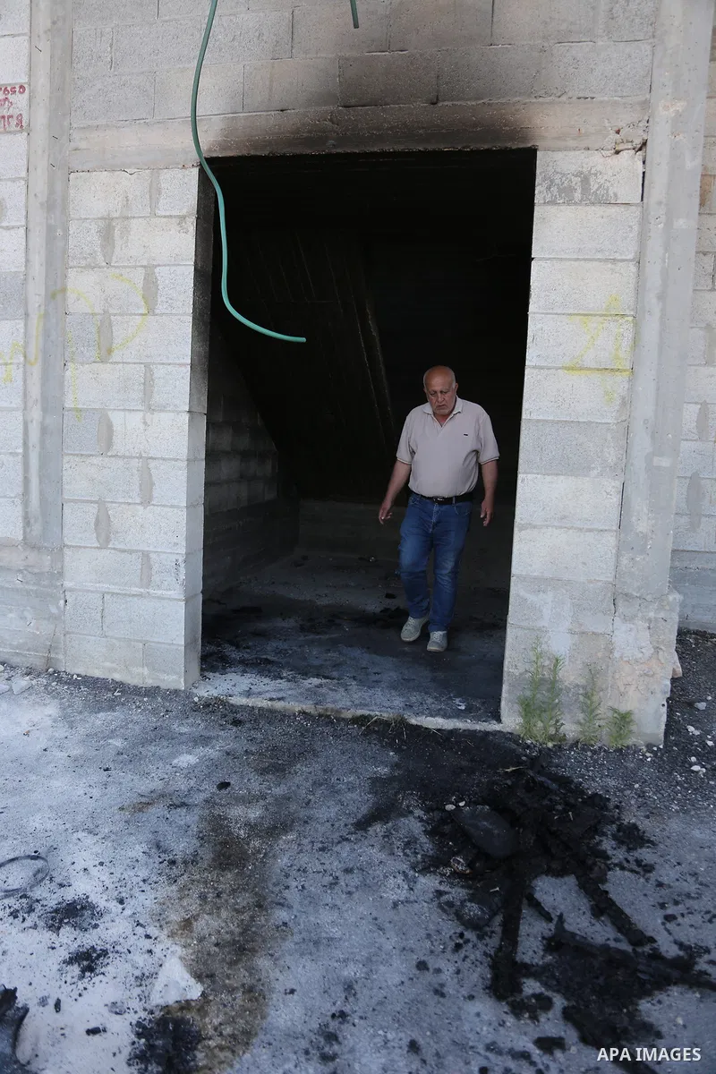 Palestinians inspect a burned house and vehicle following an attack by Israeli settlers on Palestinian homes, vehicles and property in the village of Beit Ammar, north of Nablus in the occupied West Bank, on June 9, 2026...