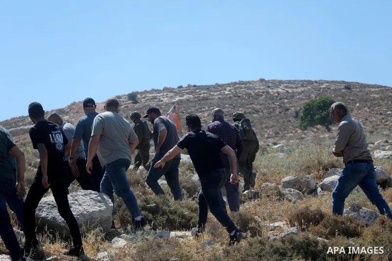 Palestinians take part in a protest against plans to confiscate land for settlement expansion in Khirbet Humsa, west of Hebron in the occupied West Bank, on June 9, 2026. Local sources said Israeli forces dispersed the d...