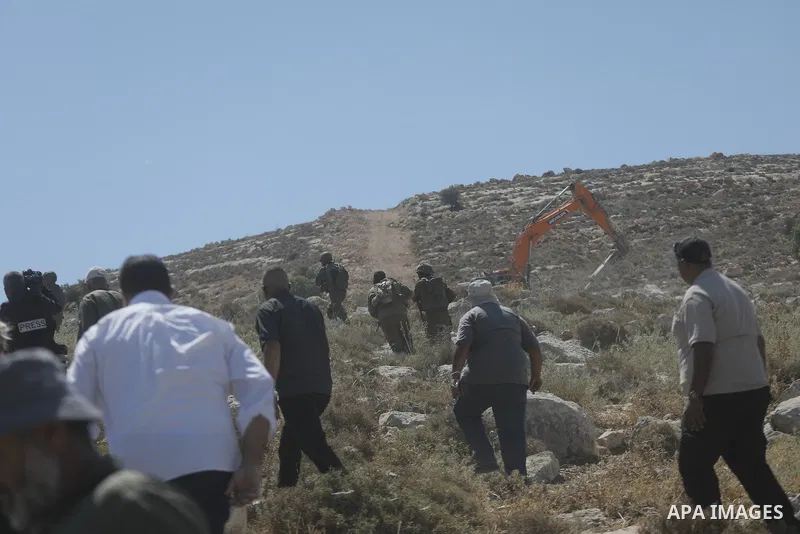 Palestinians take part in a protest against plans to confiscate land for settlement expansion in Khirbet Humsa, west of Hebron in the occupied West Bank, on June 9, 2026. Local sources said Israeli forces dispersed the d...