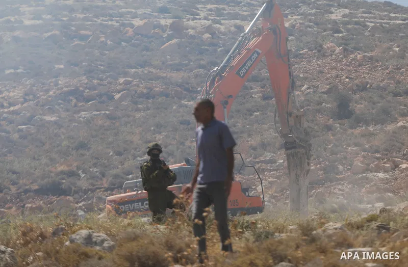 Palestinians take part in a protest against plans to confiscate land for settlement expansion in Khirbet Humsa, west of Hebron in the occupied West Bank, on June 9, 2026. Local sources said Israeli forces dispersed the d...