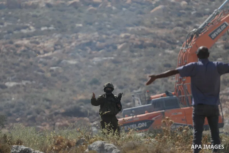 Palestinians take part in a protest against plans to confiscate land for settlement expansion in Khirbet Humsa, west of Hebron in the occupied West Bank, on June 9, 2026. Local sources said Israeli forces dispersed the d...