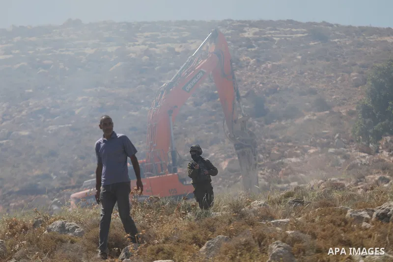 Palestinians take part in a protest against plans to confiscate land for settlement expansion in Khirbet Humsa, west of Hebron in the occupied West Bank, on June 9, 2026. Local sources said Israeli forces dispersed the d...
