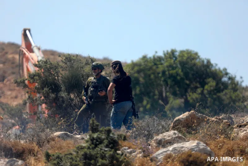 Palestinians take part in a protest against plans to confiscate land for settlement expansion in Khirbet Humsa, west of Hebron in the occupied West Bank, on June 9, 2026. Local sources said Israeli forces dispersed the d...