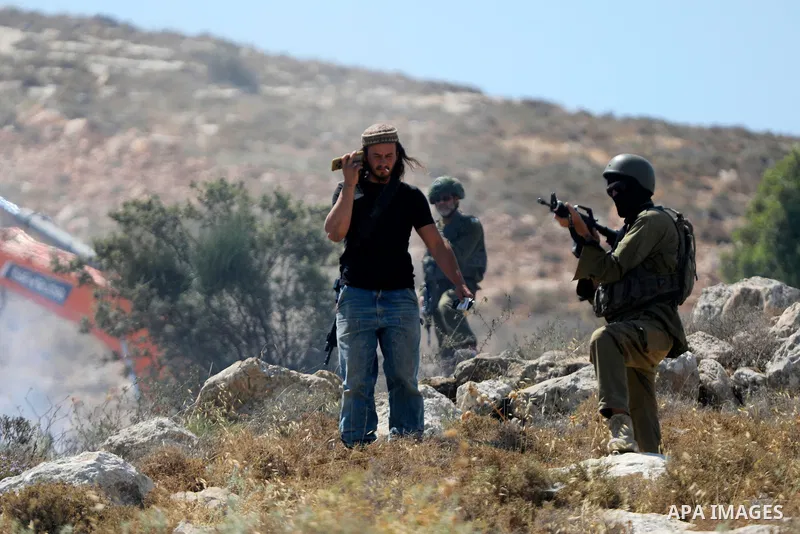 Palestinians take part in a protest against plans to confiscate land for settlement expansion in Khirbet Humsa, west of Hebron in the occupied West Bank, on June 9, 2026. Local sources said Israeli forces dispersed the d...