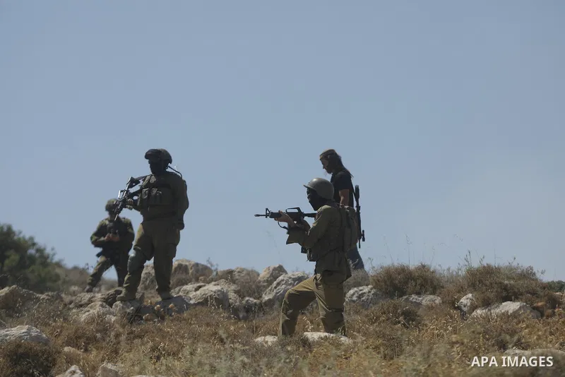 Palestinians take part in a protest against plans to confiscate land for settlement expansion in Khirbet Humsa, west of Hebron in the occupied West Bank, on June 9, 2026. Local sources said Israeli forces dispersed the d...