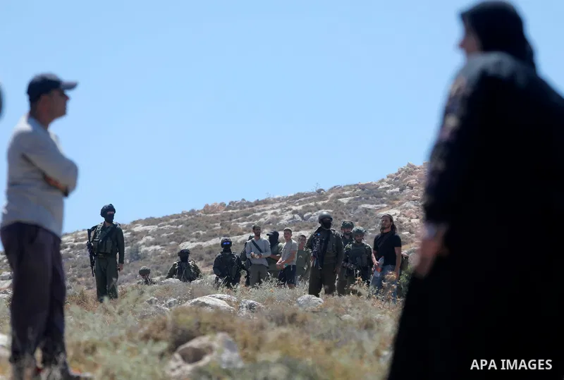 Palestinians take part in a protest against plans to confiscate land for settlement expansion in Khirbet Humsa, west of Hebron in the occupied West Bank, on June 9, 2026. Local sources said Israeli forces dispersed the d...