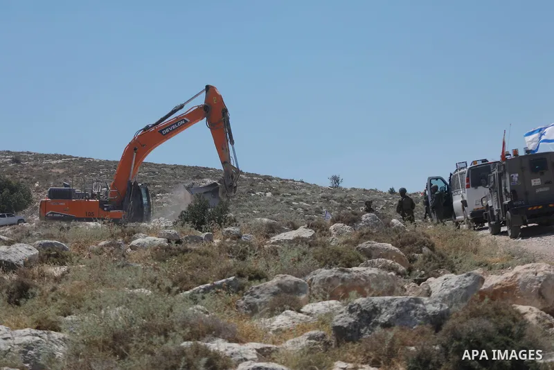 Palestinians take part in a protest against plans to confiscate land for settlement expansion in Khirbet Humsa, west of Hebron in the occupied West Bank, on June 9, 2026. Local sources said Israeli forces dispersed the d...