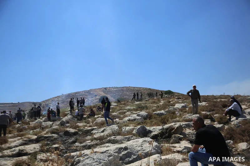 Palestinians take part in a protest against plans to confiscate land for settlement expansion in Khirbet Humsa, west of Hebron in the occupied West Bank, on June 9, 2026. Local sources said Israeli forces dispersed the d...