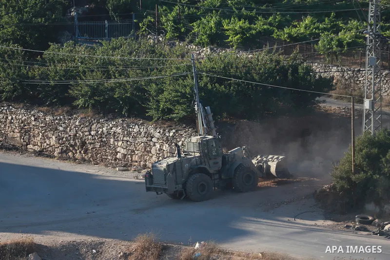 Israeli army vehicles place earth mounds and concrete blocks at roads and entrances to the town of Beit Ummar, north of Hebron in the occupied West Bank, on June 9, 2026. According to local sources, Israeli forces have c...