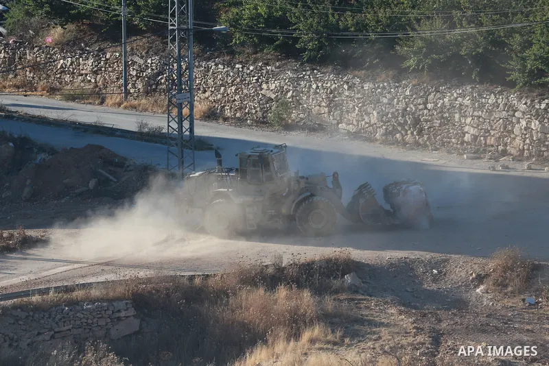 Israeli army vehicles place earth mounds and concrete blocks at roads and entrances to the town of Beit Ummar, north of Hebron in the occupied West Bank, on June 9, 2026. According to local sources, Israeli forces have c...