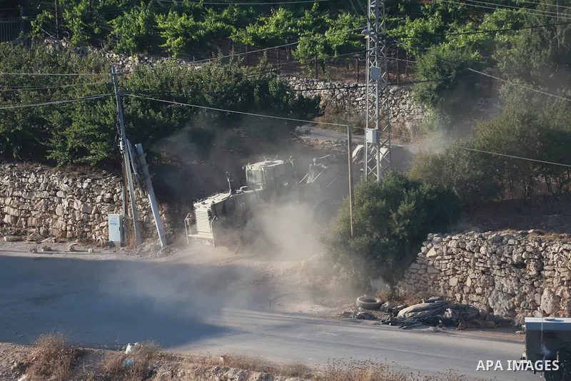 Israeli army vehicles place earth mounds and concrete blocks at roads and entrances to the town of Beit Ummar, north of Hebron in the occupied West Bank, on June 9, 2026. According to local sources, Israeli forces have c...