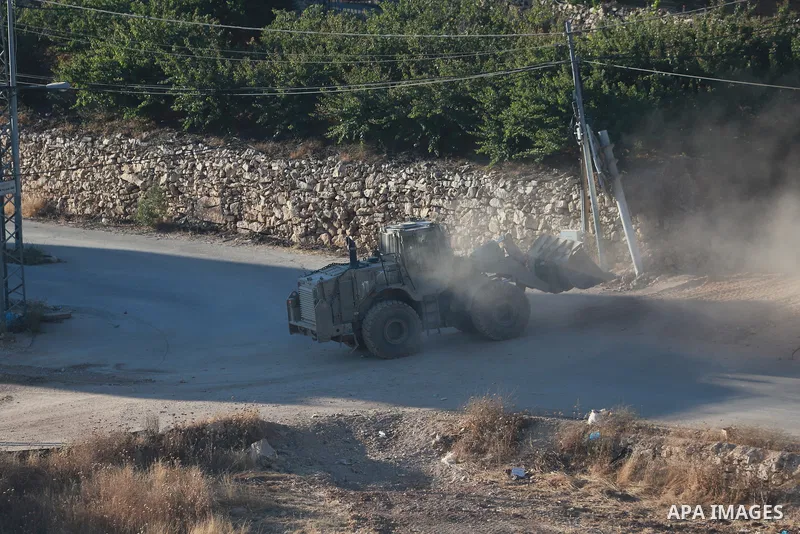 Israeli army vehicles place earth mounds and concrete blocks at roads and entrances to the town of Beit Ummar, north of Hebron in the occupied West Bank, on June 9, 2026. According to local sources, Israeli forces have c...