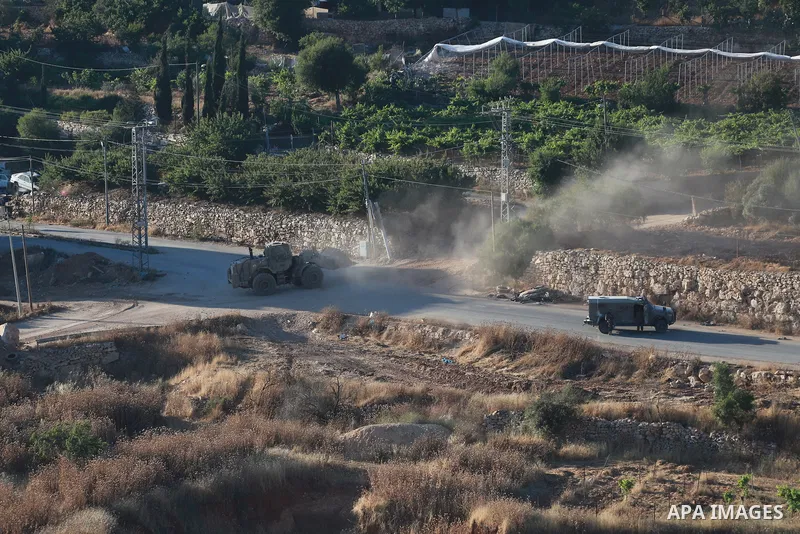 Israeli army vehicles place earth mounds and concrete blocks at roads and entrances to the town of Beit Ummar, north of Hebron in the occupied West Bank, on June 9, 2026. According to local sources, Israeli forces have c...