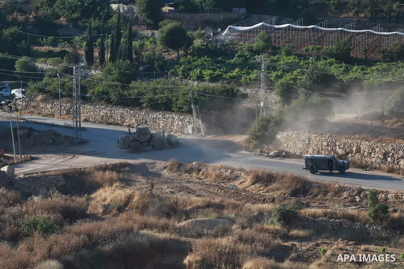 Israeli army vehicles place earth mounds and concrete blocks at roads and entrances to the town of Beit Ummar, north of Hebron in the occupied West Bank, on June 9, 2026. According to local sources, Israeli forces have c...