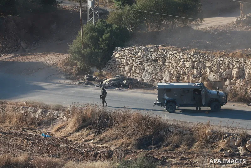 Israeli army vehicles place earth mounds and concrete blocks at roads and entrances to the town of Beit Ummar, north of Hebron in the occupied West Bank, on June 9, 2026. According to local sources, Israeli forces have c...